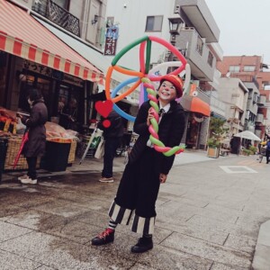 風船で傘をさすアルくん